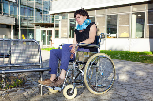 Woman tries to sit in a wheelchair