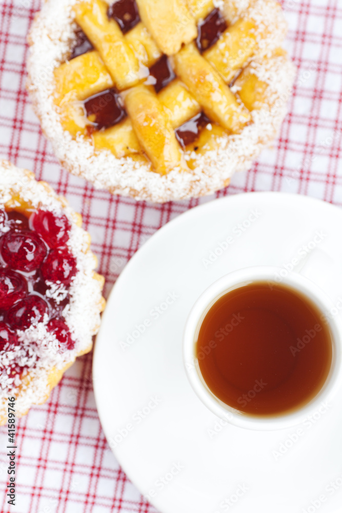 beautiful cake with berries and tea on plaid fabric beautiful cake with berries and tea on plaid fabric