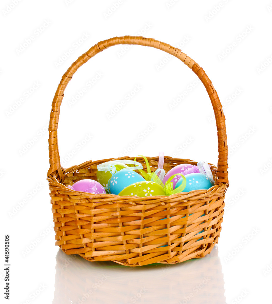 Colorful easter eggs in basket isolated on white