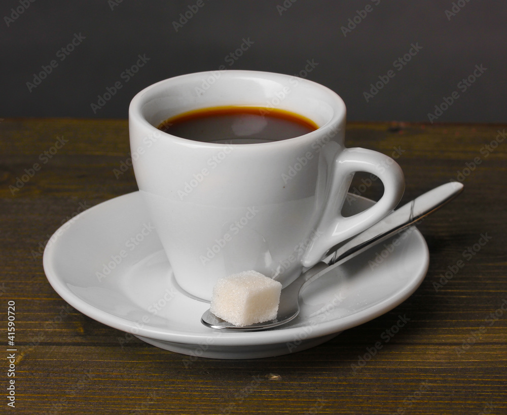 Coffee cup on wooden table on grey background Coffee cup on wooden table on grey background