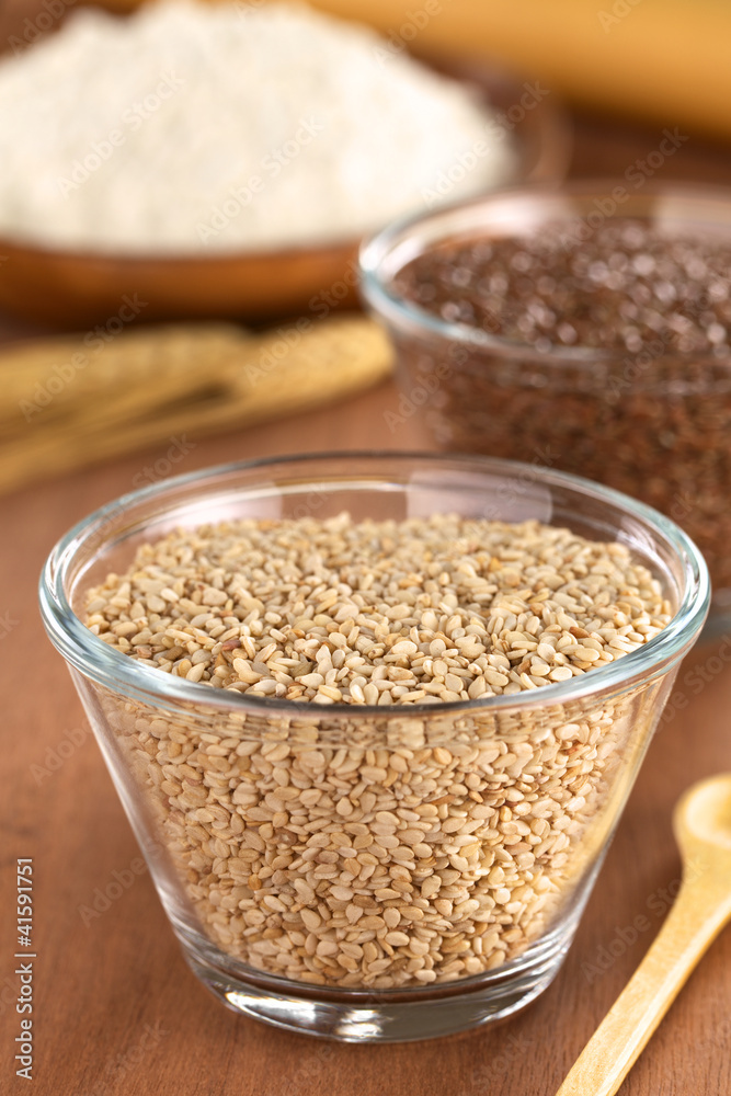 Sesame seeds in glass bowl with flax seeds and flour Sesame seeds in glass bowl with flax seeds and flour