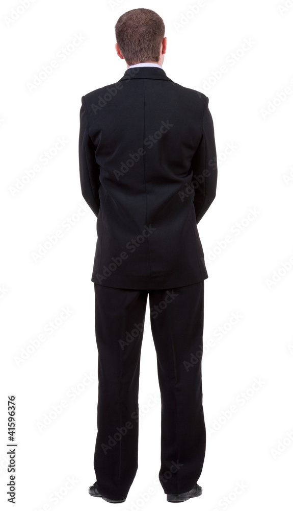 back view of young guy in black suit watching. back view of young guy in black suit watching.