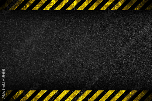 Dark background with yellow caution stripes