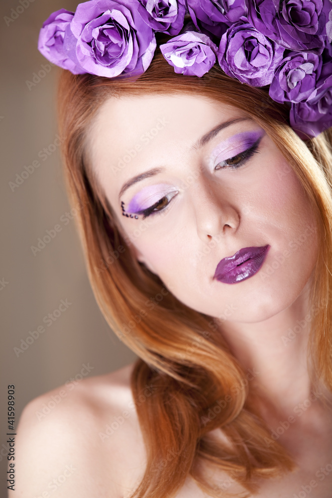 Portrait of beautiful redhead girl with style make-up and flower