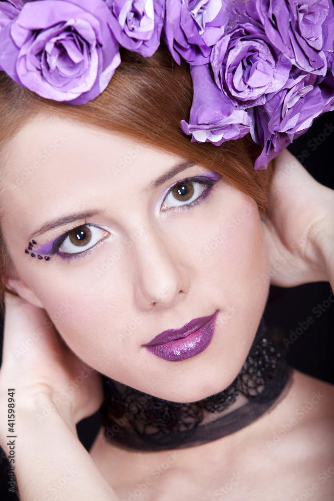 Naklejka premium Portrait of beautiful redhead girl with style make-up and flower