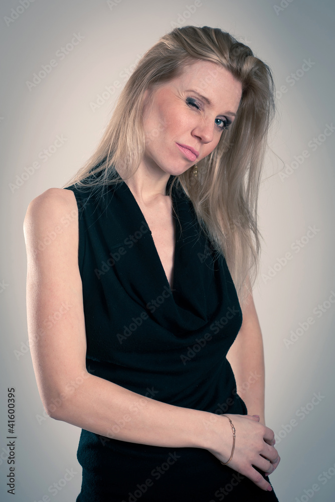 Beautiful blonde caucasian woman with black dress blinking. Beautiful blonde caucasian woman with black dress blinking.