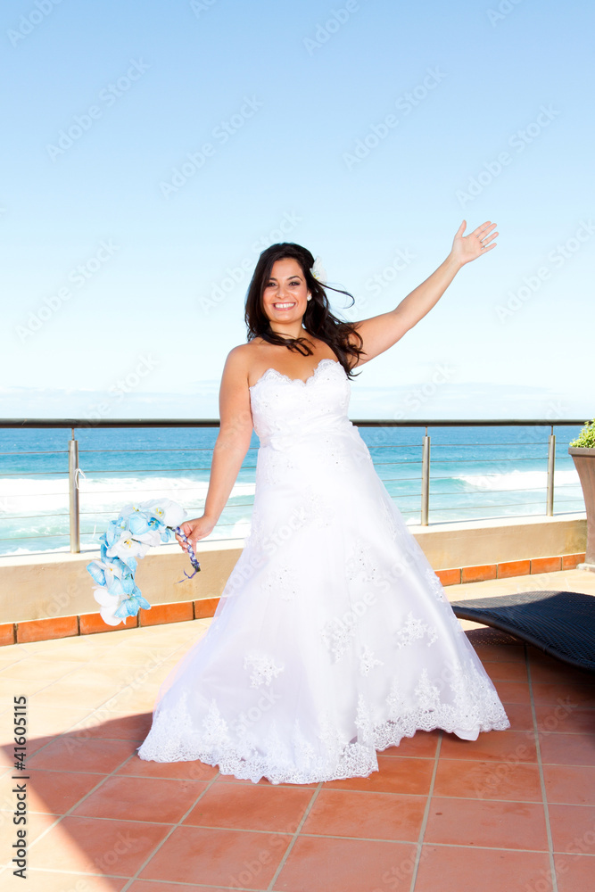 cheerful young bride on balcony