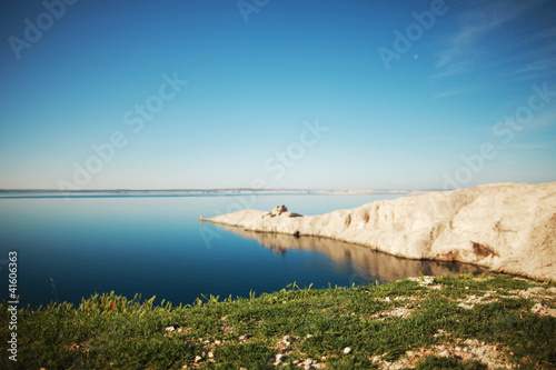 Lighthouse at Adriatic sea by island landscape