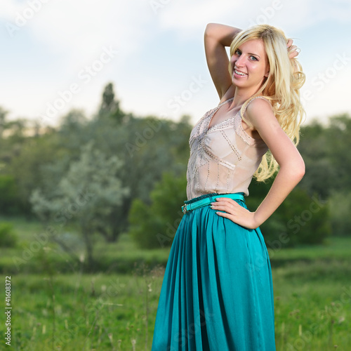 Portrait of pretty girl standing in the field