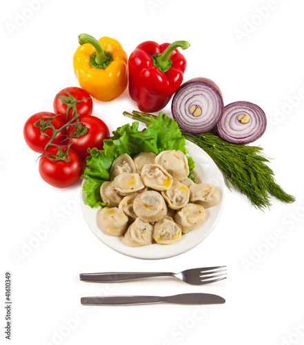 Tasty pelmeni with tomato and salad