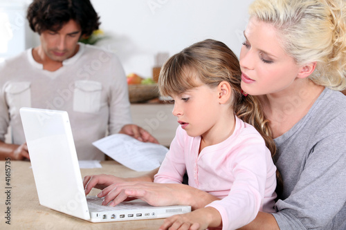 Mother with girl and computer