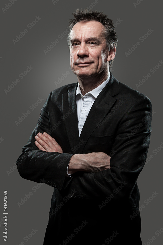 Smug Middle Age Business Arms Folded on Grey Background Smug Middle Age Business Arms Folded on Grey Background
