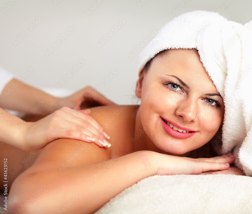 An attractive woman getting spa treatment, isolated on white An attractive woman getting spa treatment, isolated on white