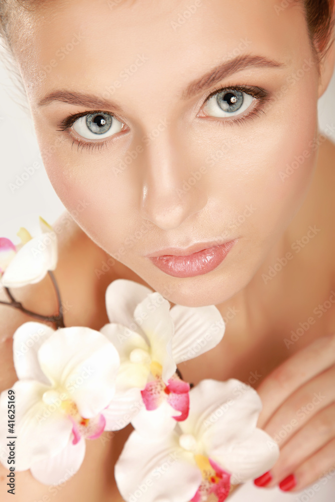 A young woman with orchid, isolated on white