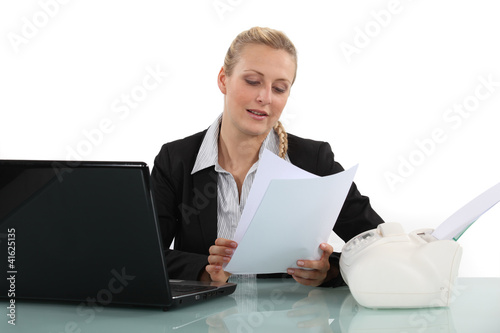 Blond woman reading fax message