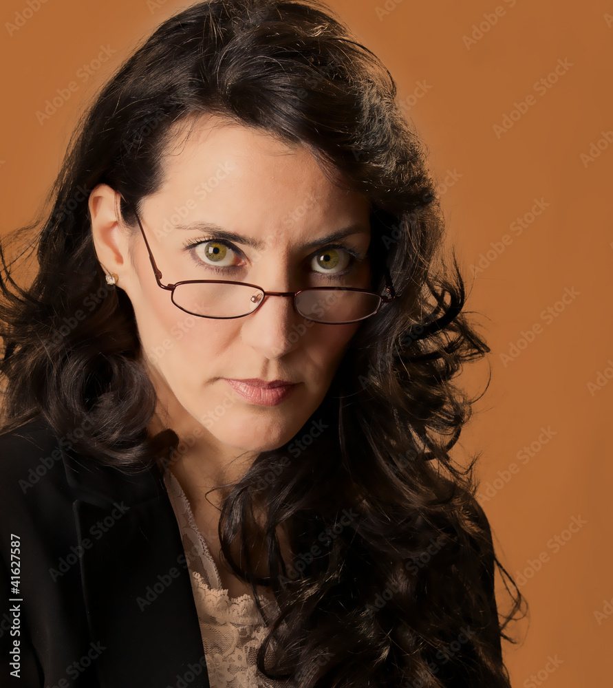 Woman looking over her glasses at you.. Stock Photo | Adobe Stock