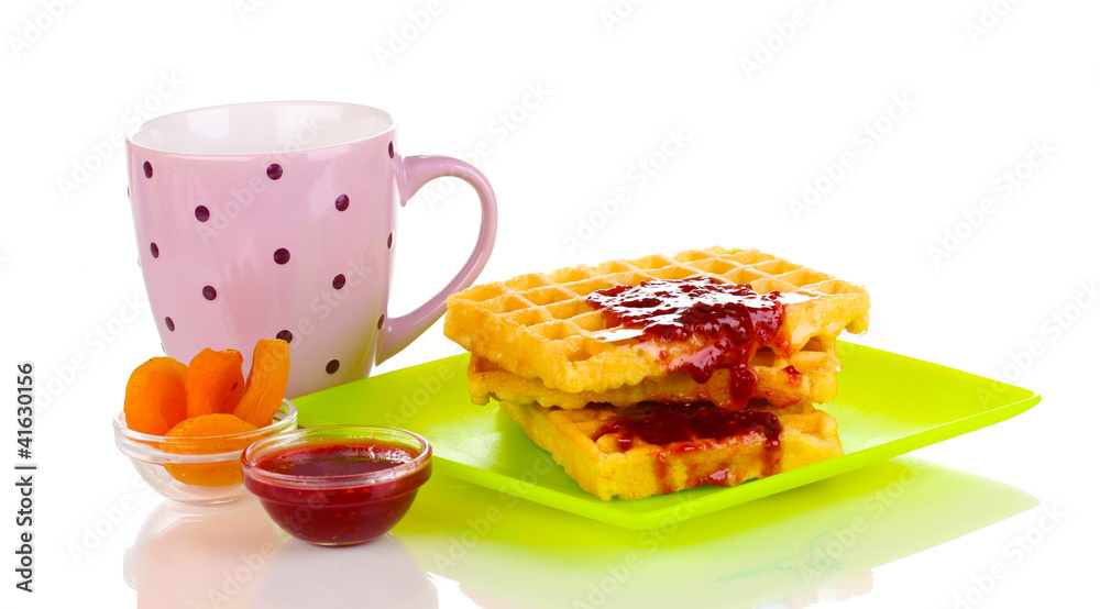 Tasty waffles with jam on plate isolated on white Tasty waffles with jam on plate isolated on white