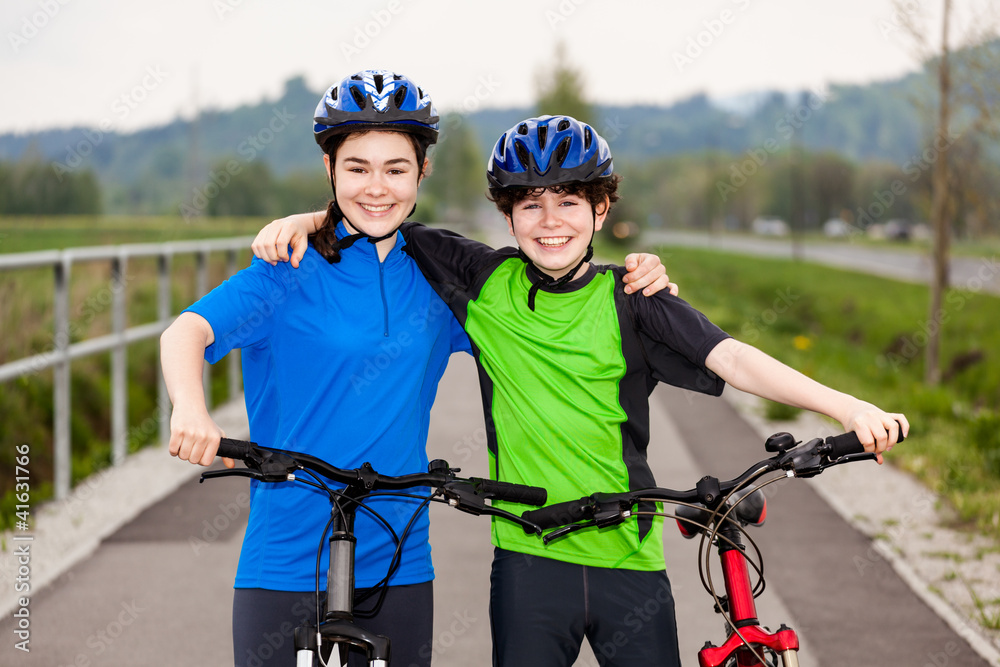 Girl and boy biking Girl and boy biking