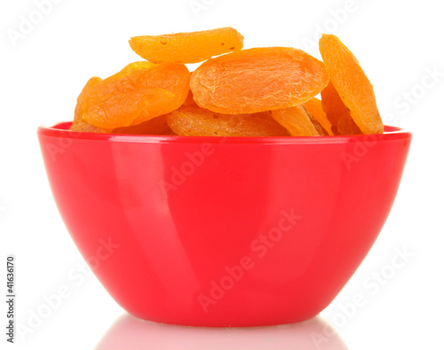 delicious dried apricots in bright bowl isolated on white