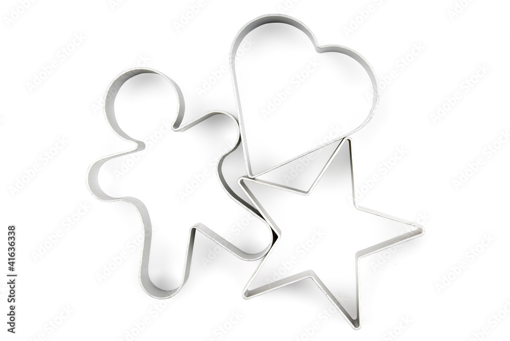 Star, gingerbread and heart pastry cutters on white. Star, gingerbread and heart pastry cutters on white.