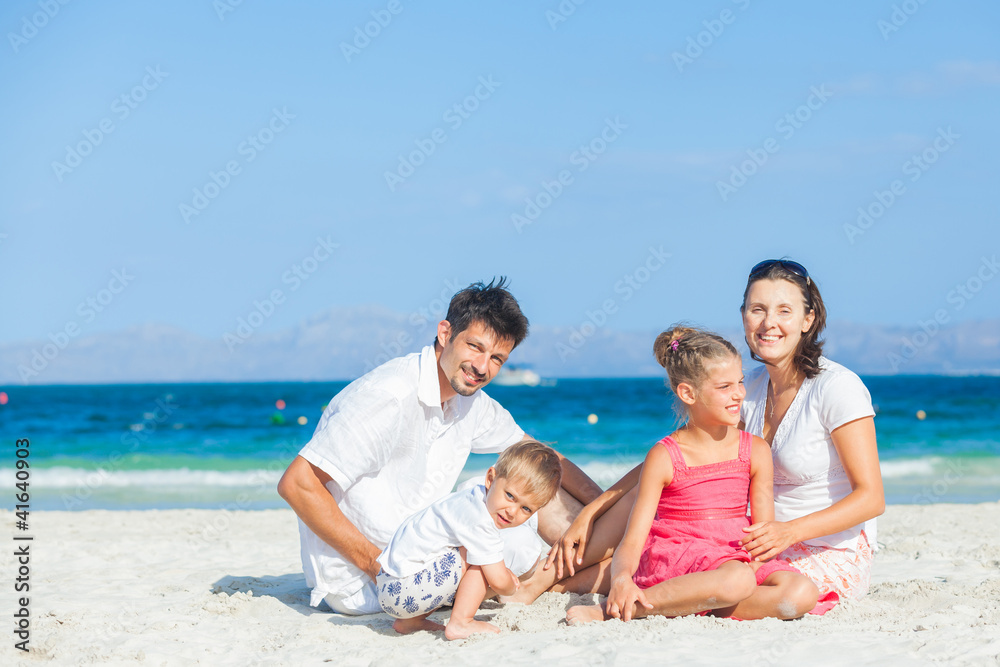Family of four on tropical beach Family of four on tropical beach
