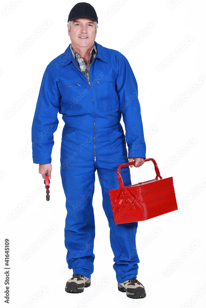Tradesman holding a tool and his toolbox Tradesman holding a tool and his toolbox