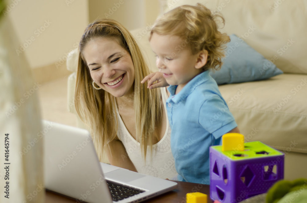 Mother and son having fun with a computer Mother and son having fun with a computer