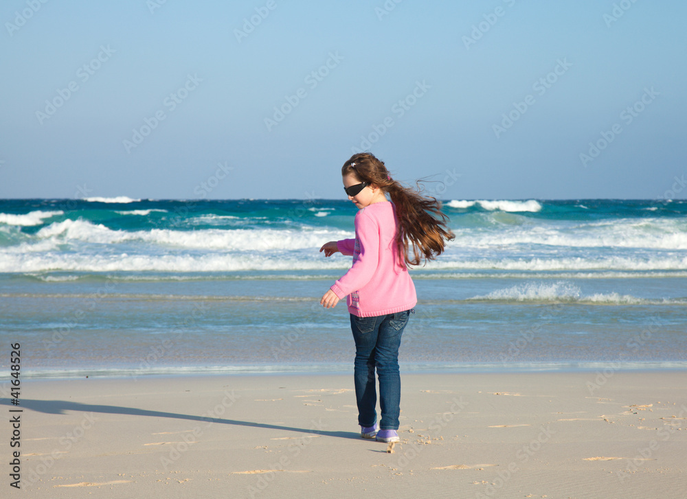 small girl on a evening beach