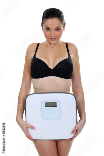Woman in underwear in front of scales