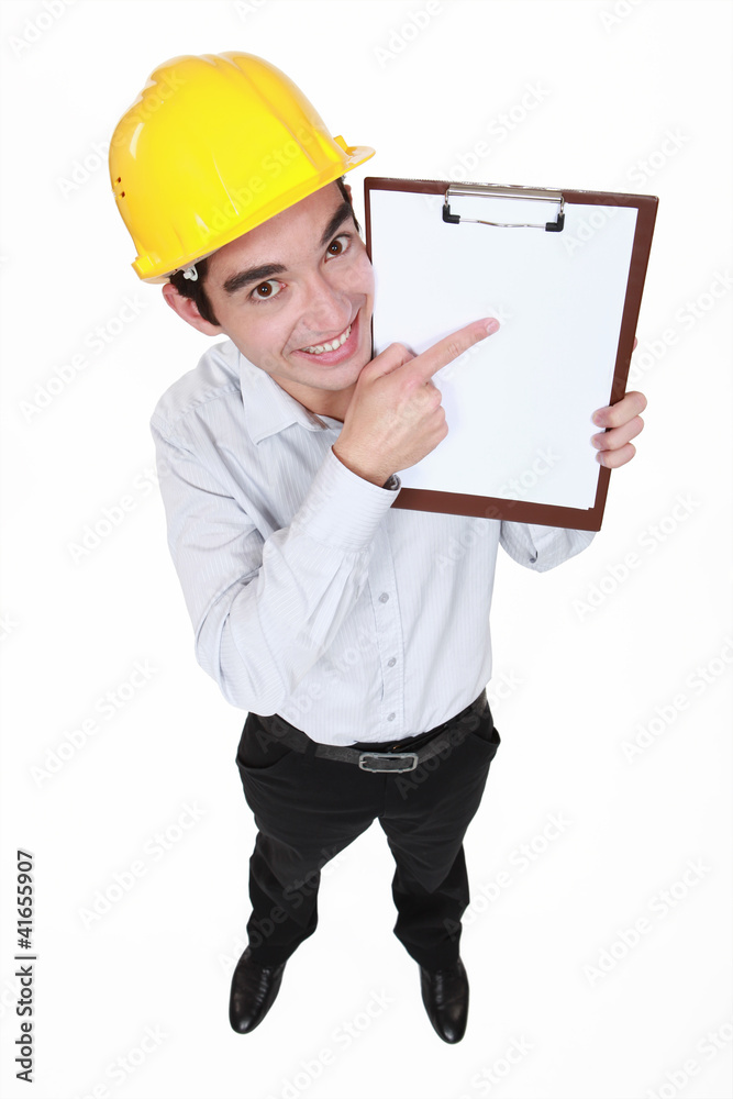 Happy man pointing at clip board Happy man pointing at clip board