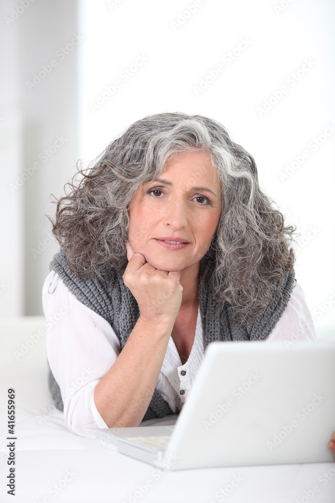 Portrait of a Senior woman in front of a laptop computer Portrait of a Senior woman in front of a laptop computer