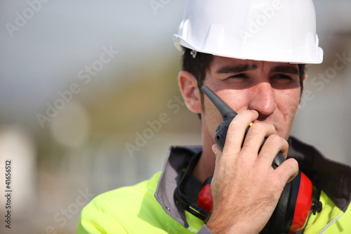 Foreman using radio to give instructions