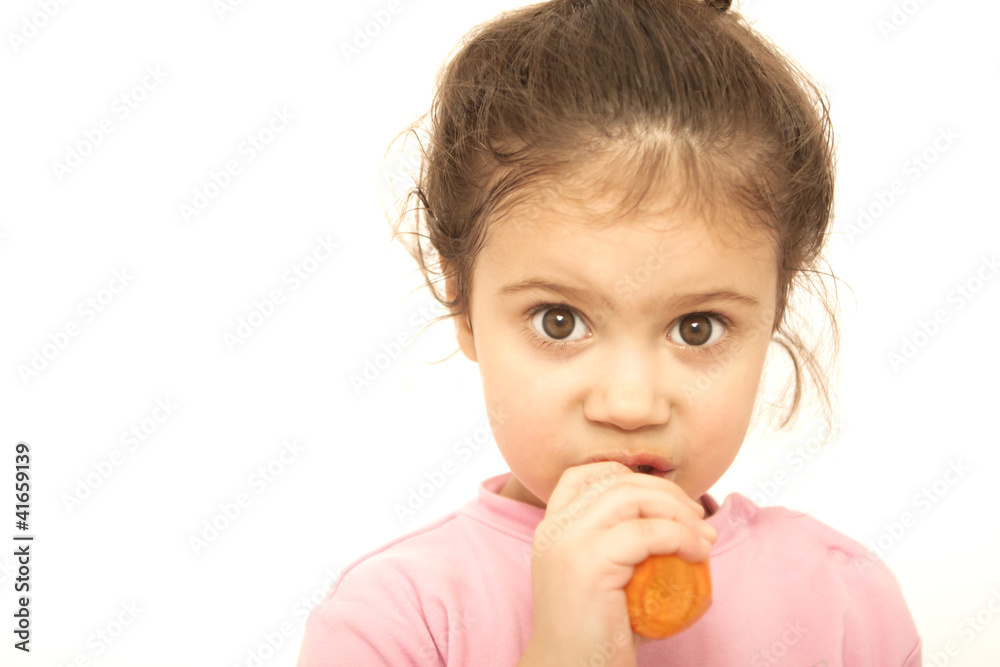 Little girl eating carrot over the white background Little girl eating carrot over the white background