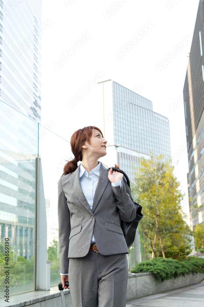 Beautiful business woman walking outside her office. Portrait of Beautiful business woman walking outside her office. Portrait of