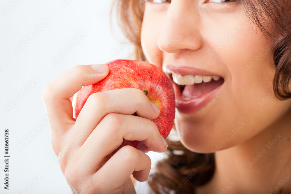 Young woman bites in a apple