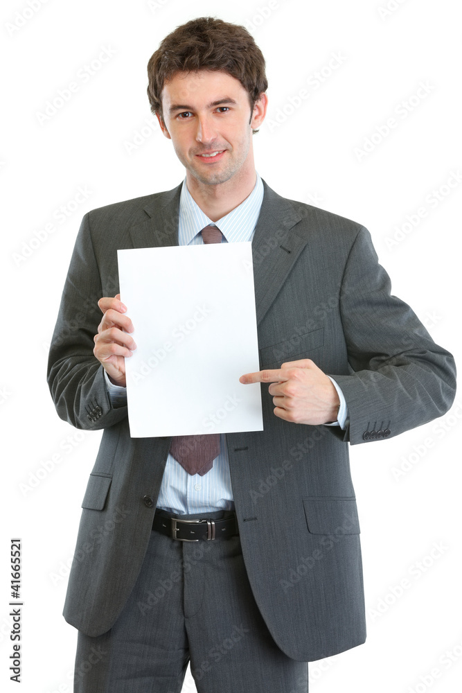 Modern businessman pointing on blank paper sheet Modern businessman pointing on blank paper sheet