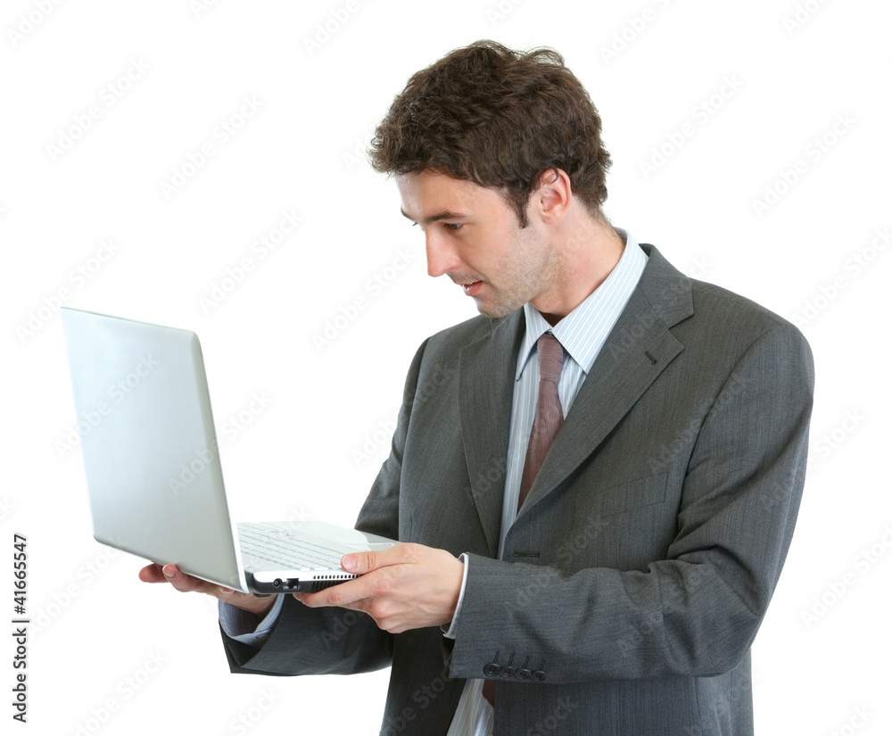 Modern businessman looking in laptops screen Modern businessman looking in laptops screen