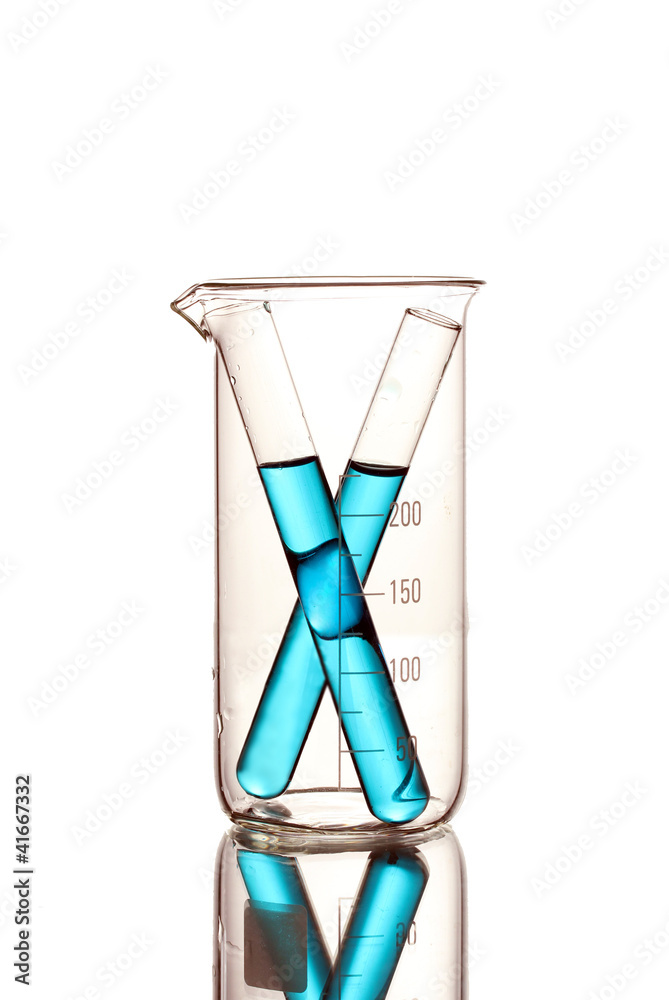 Laboratory tubes with blue liquid in measuring beaker Laboratory tubes with blue liquid in measuring beaker