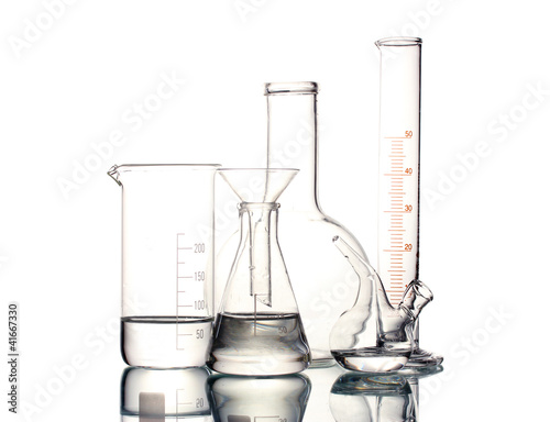 Different laboratory glassware with water and empty with photo