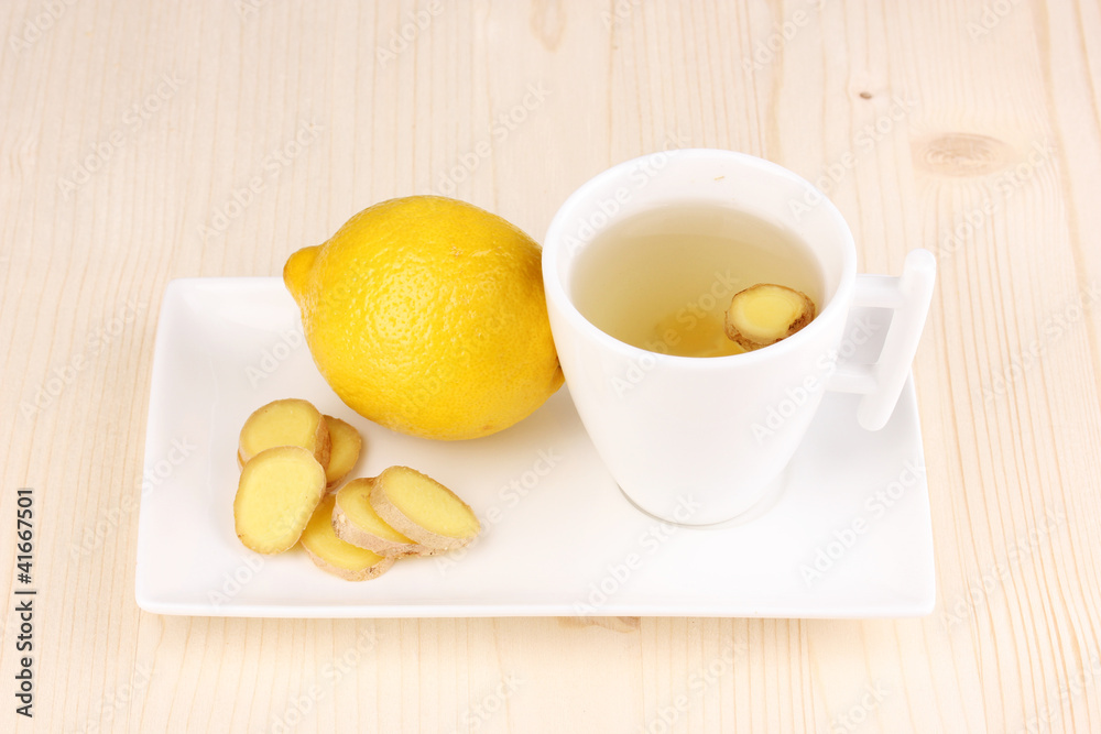 Healthy ginger tea with lemon on wooden background Healthy ginger tea with lemon on wooden background