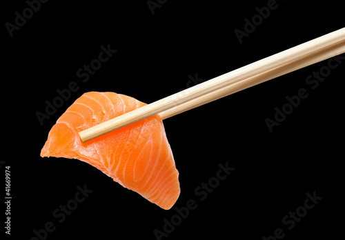 Chopsticks with sliced raw salmon