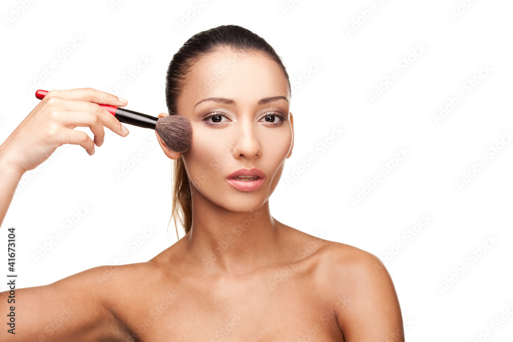 Young beautiful woman applying makeup Young beautiful woman applying makeup