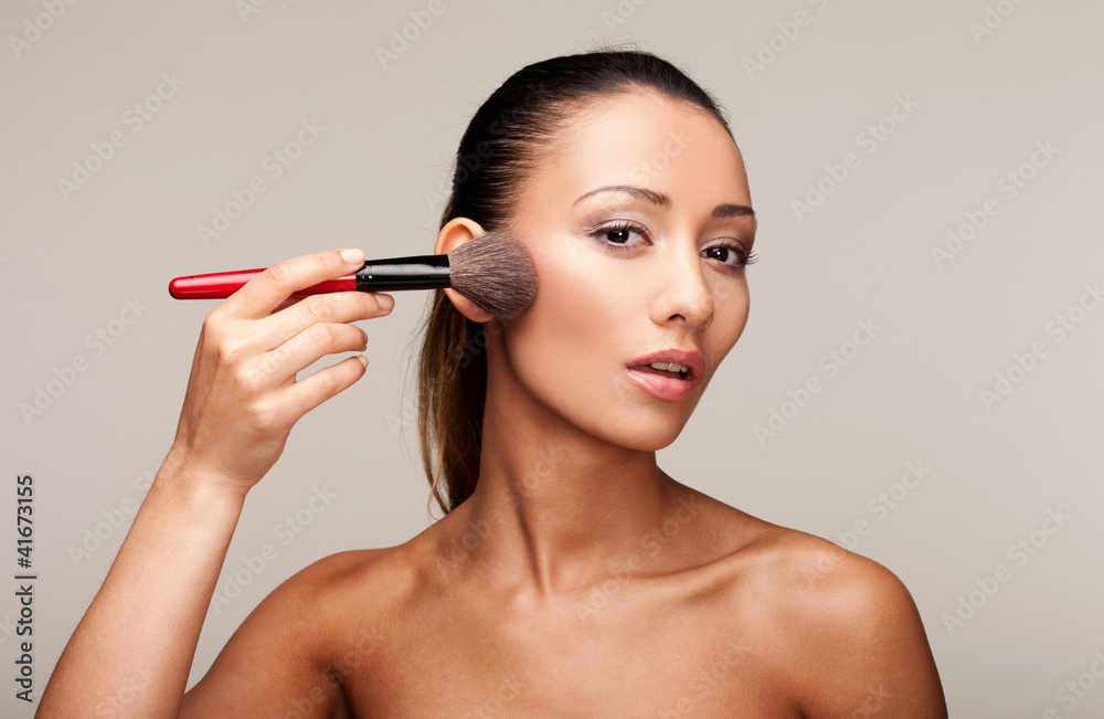 Young beautiful woman applying makeup Young beautiful woman applying makeup