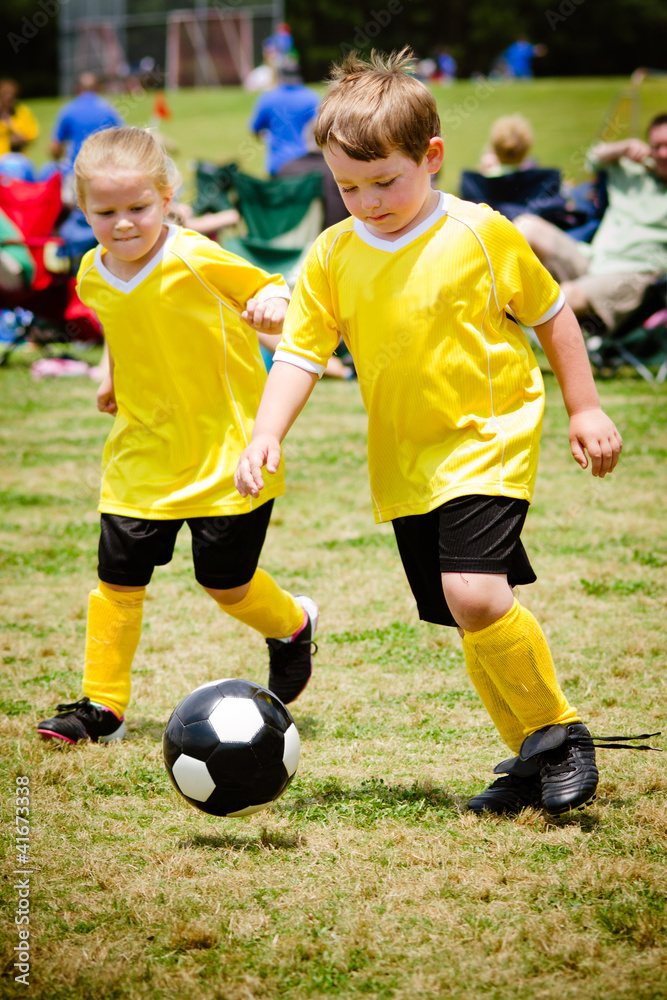 Children playing soccer in organized youth game Children playing soccer in organized youth game