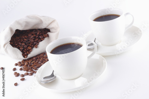 Coffee beans with two cups