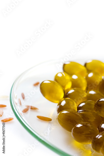 transparent pills of vitamin E on dish and rice