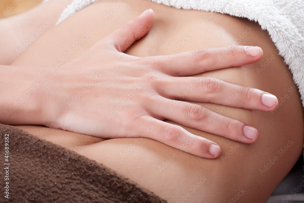 Naklejka premium massaging the belly