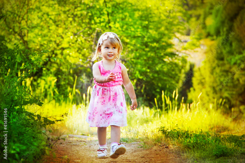 Happy funny little girl walking on road, nature outdoors Happy funny little girl walking on road, nature outdoors