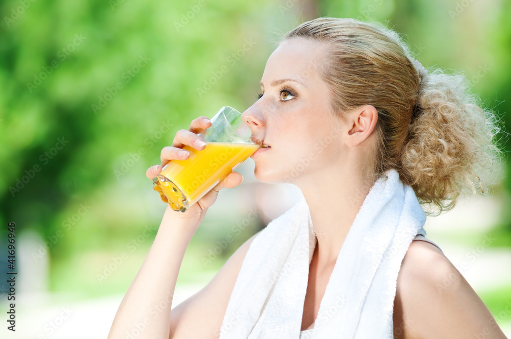 Woman drinking juice after exercise Woman drinking juice after exercise