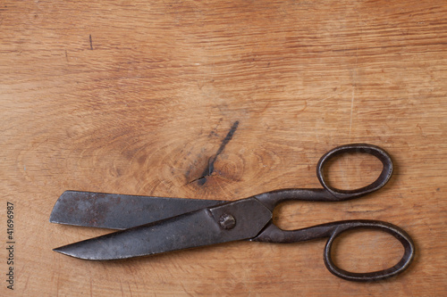 Old scissors on wood